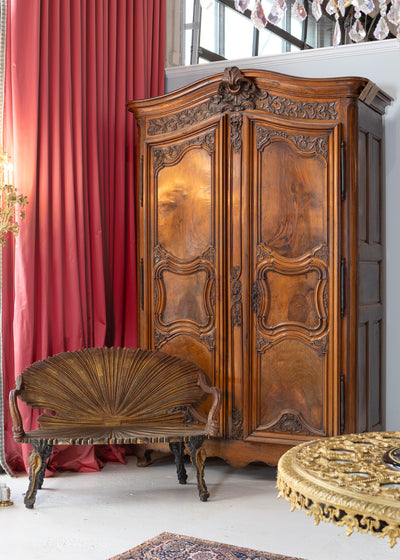 Exquisite armoire crafted from high-quality wood, featuring decorative carvings.